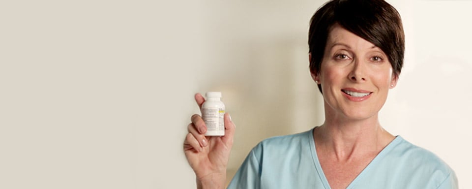 Woman smiling and holding up a bottle of Tylenol